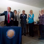 Gov. Bill Walker hands out pens after the signing of SB 91 into law at Haven House on Monday.