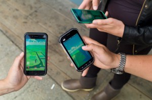 Players chase Pokémon while playing Nintendo's newest phone app, Pokémon Go, in downtown Juneau on Tuesday.