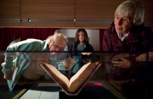 Vaughn Westcott, left, Fran Ritts, visiting from Long Island, New York, center, and Barbara Pavitt look at a First Folio edition of William Shakespeare's plays that went on display at the State Library, Archives and Museum building on Tuesday. One of only 234 known surviving copies, the nearly 400-year-old book containing 36 plays will be on display until Aug. 24.