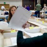 Hand-count team members Sharlette Scudder, left, and Julia Ann Orsborn examine a ballot from the statewide primary election at Centennial Hall on Monday.