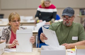 Hand-count team members Christine Niemi, left, and James Fowlkes count ballots from the statewide primary election at Centennial Hall on Monday.