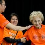 Teacher Hans Chester, left, and Barbara Cadiente-Nelson, center, thank elder Selina Everson for speaking to students, teachers and parents celebrating Orange Shirt Day in the Elizabeth Peratrovich Hall on Friday.