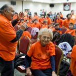 Elders, including David Katzeek, left, and Selina Everson, watch students enter Elizabeth Peratrovich Hall for Orange Shirt Day on Friday.