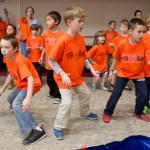 Students dance to celebrate Orange Shirt Day in the Elizabeth Peratrovich Hall on Friday.