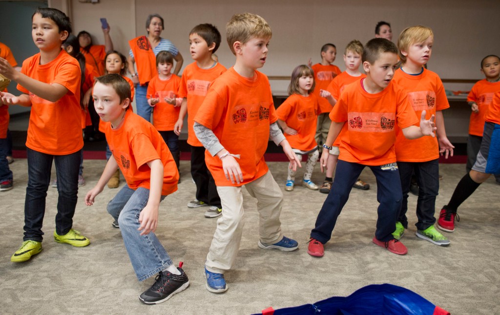 Students dance to celebrate Orange Shirt Day in the Elizabeth Peratrovich Hall on Friday.