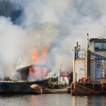 Tugboat Consul D burns outside of Aurora Harbor on Monday.