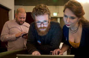 House District 34 candidate Justin Parish, center, watches results come in with campaign manager Steve SueWing, left, and volunteer Monica Todden at Rockwell on Tuesday. Parish unseated Rep. Cathy Muñoz.