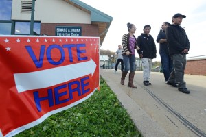 From left, Pri Paw, Priki Dee, Chris Sunderlin and Par Der Wae leave the Parkway Center after voting on Election Day in Utica, New York, Tuesday. Pri Paw, Priki Dee and Par Der Wae came to Utica as refugees.