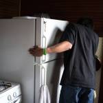 Russell James reviews the energy load for home appliances during a home energy audit demonstration at a Kake home in July. (Courtesy Photo | Bethany Goodrich)