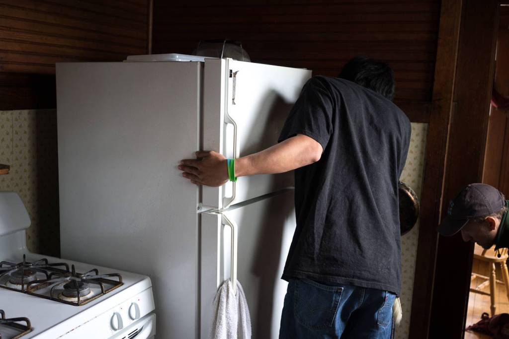 Russell James reviews the energy load for home appliances during a home energy audit demonstration at a Kake home in July. (Courtesy Photo | Bethany Goodrich)