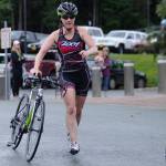 Kimberly Campbell runs after finishing the biking leg of the 2018 Aukeman Triathlon at the University of Alaska Southeast . (Nolin Ainsworth | Juneau Empire)