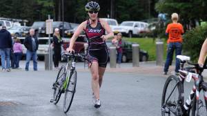 Kimberly Campbell runs after finishing the biking leg of the 2018 Aukeman Triathlon at the University of Alaska Southeast . (Nolin Ainsworth | Juneau Empire)
