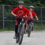 Landry Dillingham, 10, outraces Alder Caouette, 10, at the finish line for third place in the Douglas Dirt Derby on Saturday, Aug. 4, 2018 at Savikko Park in Douglas. The event raised around $6,000 for the American Diabetes Association. (Alex McCarthy | Juneau Empire)