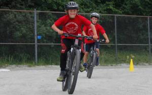 Landry Dillingham, 10, outraces Alder Caouette, 10, at the finish line for third place in the Douglas Dirt Derby on Saturday, Aug. 4, 2018 at Savikko Park in Douglas. The event raised around $6,000 for the American Diabetes Association. (Alex McCarthy | Juneau Empire)