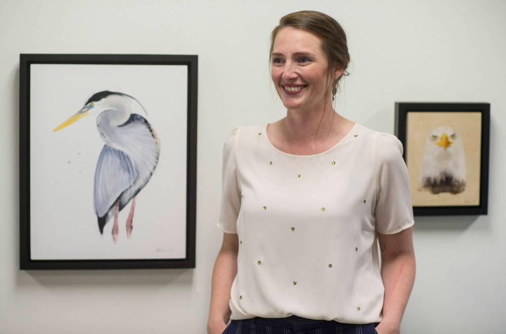 Jessica Hahnlen visits with guest during her solo watercolor show Creatures + Collections at the Juneau Arts & Humanities Council gallery during First Friday. (Michael Penn | Capital City Weekly)