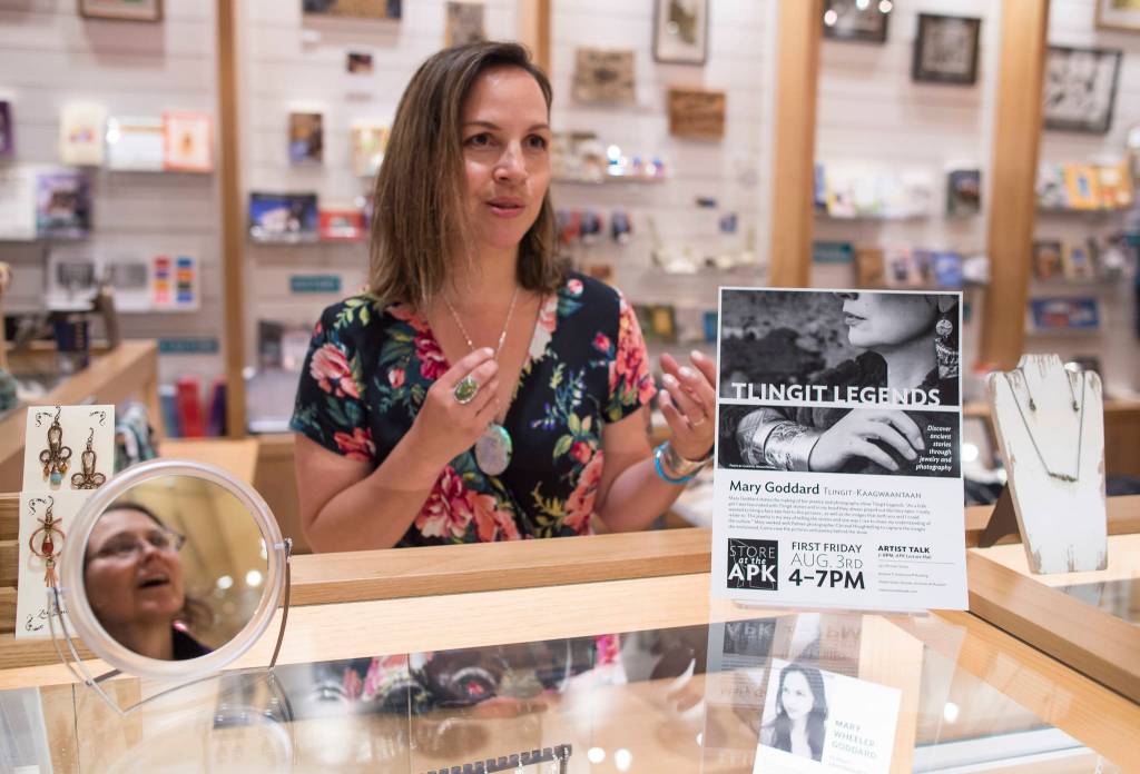 Mary Goddard, Tlingit-Kaagwaantaan, speaks to visitor about her jewelry at the Store at the Father Andrew P. Kashevaroff State Library, Archives, and Museum during First Friday, Aug. 3. (Michael Penn | Capital City Weekly)