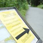 A sign at the start of Nugget Falls Trail, near the Mendenhall Glacier, warns visitors of flooding on the popular pathway. (Kevin Gullufsen | Juneau Empire)