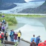 Visitors walk to Photo Point above a flooded Mendenhall Lake on Wednesday, Aug. 8, 2018. (Kevin Gullufsen | Juneau Empire)