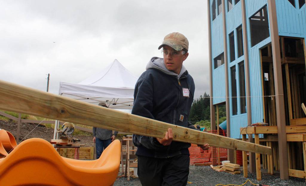 Samson Anderson, 14, helps with the rebuild of Project Playground on Wednesday, Aug. 8, 2018. (Alex McCarthy | Juneau Empire)