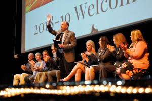 In a photo provided by the governors office, Gov. Bill Walker waves from the stage at Lathrop High School during a signing ceremony for four bills Friday, Aug. 10, 2018. (Courtesy photo)