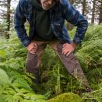 Ben Patterson, the citys park maintenance supervisor, tries to read a moss-covered gravestone as he gives a tour of the cemetery sections in Douglas on Monday, August 13, 2018. (Michael Penn | Juneau Empire)