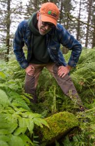 Ben Patterson, the citys park maintenance supervisor, tries to read a moss-covered gravestone as he gives a tour of the cemetery sections in Douglas on Monday, August 13, 2018. (Michael Penn | Juneau Empire)