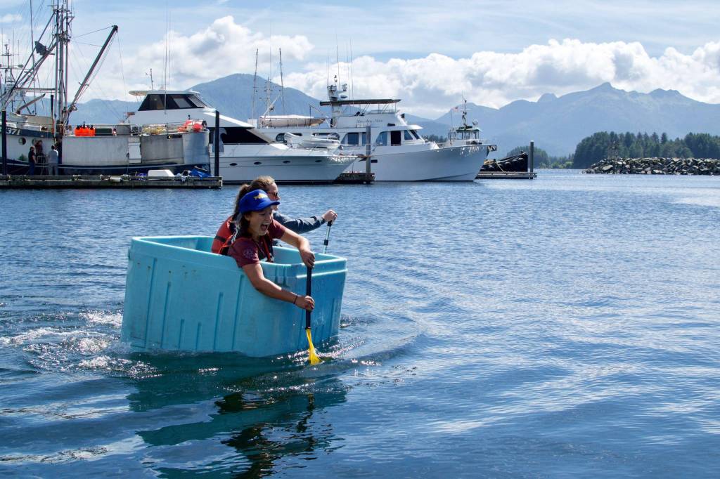 Carly Dennis paddling to the finish line in the tote race. (Maia Mares | For the Capital City Weekly)