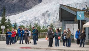 Visitors wait for the buses at the Mendenhall Glacier Visitor Center on Thursday, August 16, 2018. (Michael Penn | Juneau Empire)