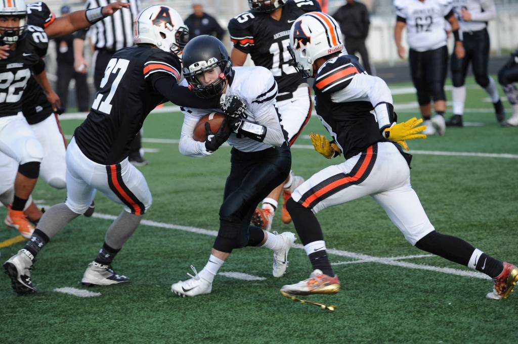 Juneaus Hansel Hinckle runs between West defenders. (Michael Dinneen | For the Juneau Empire)