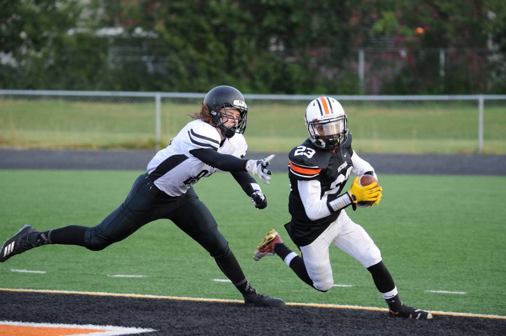 Juneaus Dawson Hickok reaches for a West defender after an interception. (Michael Dinneen | For the Juneau Empire)