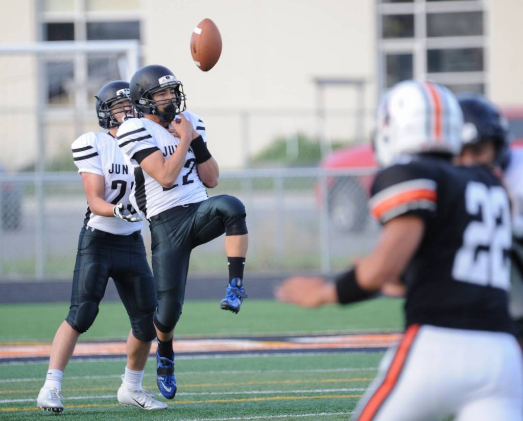 Juneaus Ali Beya has difficulty handling a kickoff in front of teammate Cody Morehouse. (Michael Dinneen | For the Juneau Empire)