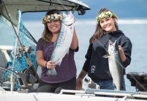 Tesla Cox, left, and Deanne Fuller on the Lil Mermaid show their silver salmon during the 72nd Annual Golden North Salmon Derby on Friday, August 17, 2018, sponsored by the Territorial Sportsmen. (Michael Penn | Juneau Empire)