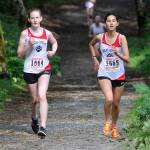 Juneau-Douglas McKenna McNutt, left, and Sosan Monsef run in the Douglas Island Mini-Meet on the Treadwell Mine Historic Trails on Saturday. (Nolin Ainsworth | Juneau Empire)