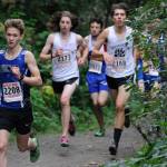 Thunder Mountains Tucker Kelly leads Juneau-Douglas Ronan Davis, right, and Finn Morley, middle, during the Douglas Island Mini-Meet on the Treadwell Mine Historic Trails on Saturday. (Nolin Ainsworth | Juneau Empire)