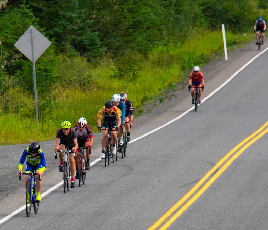Will Coleman, left, is followed by Allan Spangler, David Jackson, Hiram Henry and others near the start of the second stage of the Tour of Juneau up Eaglecrest Road on Saturday. (Richard McGrail | Juneau Empire)