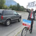 Haines Borough Assemblyman Tom Morphet, Democratic candidate for House District 33, encourages drivers to vote on Tuesday, Aug. 21, 2018 alongside Egan Drive near the Douglas Bridge. (James Brooks | Juneau Empire)