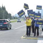 Supporters of Andi Story, Democratic candidate for House District 34, wave signs Tuesday, Aug. 21, 2018 at the McNugget intersection. (James Brooks | Juneau Empire)