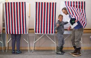 Buchanan Willoughby votes with his son, Paxton, 7, at Bartlett Regional Hospital on Tuesday, August 21, 2018. (Michael Penn | Juneau Empire)