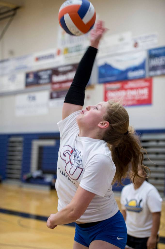 Senior Audrey Welling spikes the ball during Thunder Mountain High School varsity volleyball practice at TMHS on Wednesday, August 15, 2018. (Michael Penn | Juneau Empire)