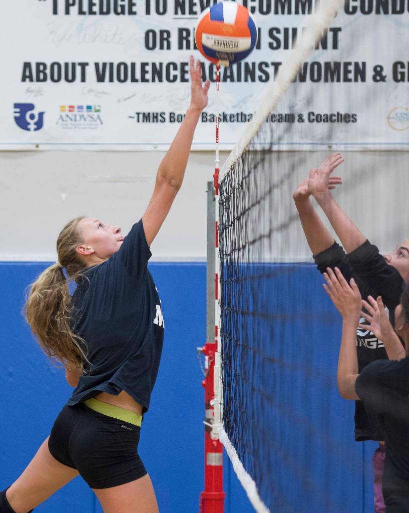 Sophomore Lilyan Smith taps the ball over during Thunder Mountain High School varsity volleyball practice at TMHS on Wednesday, August 15, 2018. (Michael Penn | Juneau Empire)