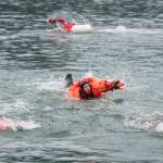 U.S. Coast Guard teams from the Guard Cutters Hickory, Sycamore, Anthony Petit and Kukui compete in the survival suit swim during the Buoy Tender Olympics at Station Juneau on Wednesday, Aug. 22, 2018. (Michael Penn | Juneau Empire)