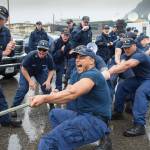 DC3 Marcus Osborne, center, pulls with his Sycamore teammates as they are encouraged by shipmates, including Lt. Commander Collin Bronson, left, during the Buoy Tender Olympics at Station Juneau on Wednesday, Aug. 22, 2018. (Michael Penn | Juneau Empire)