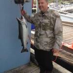 James McKnight holds a coho salmon he caught on Saturday, Aug. 18, 2018 at the Golden North Salmon Derby. The fish, weighed at 17.7 pounds, was the largest one caught at the derby. (Courtesy Photo | Derby Committee)