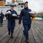 Chefs Berkeley Scott and Matthew Koran, right, from the buoy tender Hickory, walk their burgers to waiting contest judges on Thursday, Aug. 23, 2018. (Michael Penn | Juneau Empire)