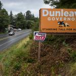 Mike Dunleavy for governor and Jerry Nankervis for state house election signs are seen on Egan Drive at 17 Mile on Friday, Aug. 24, 2018. Alaska statute states signs on private or commercial property cannot be located within 660 feet of a state-maintained road or with the purpose of their message being read from the main traveled way. (Michael Penn | Juneau Empire)