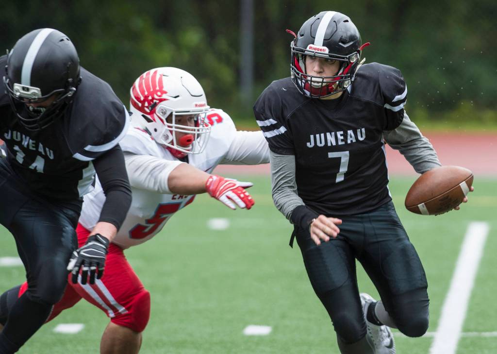Juneau Footballs Cooper Kriegmont is sacked by Easts Daryl Delaguion at Adair-Kennedy Memorial Field on Saturday, Aug. 25, 2018. East won 40-0. (Michael Penn | Juneau Empire)