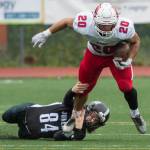 Juneau Footballs Dawson Kickok tackles Easts Shamir Staten at Adair-Kennedy Memorial Field on Saturday, Aug. 25, 2018. East won 40-0. (Michael Penn | Juneau Empire)