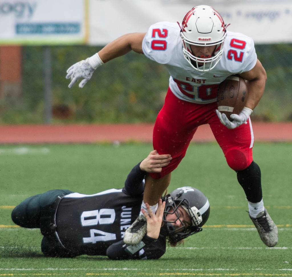 Juneau Footballs Dawson Kickok tackles Easts Shamir Staten at Adair-Kennedy Memorial Field on Saturday, Aug. 25, 2018. East won 40-0. (Michael Penn | Juneau Empire)