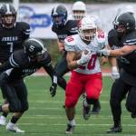 Juneau Footballs Hansel Hinckle, left, and Noah Heidersdorf, right, chase Easts Shamir Staten at Adair-Kennedy Memorial Field on Saturday, Aug. 25, 2018. East won 40-0. (Michael Penn | Juneau Empire)