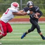 Juneau Footballs Ali Beya, right, is tackled by Easts Earl Apineru at Adair-Kennedy Memorial Field on Saturday, Aug. 25, 2018. East won 40-0. (Michael Penn | Juneau Empire)